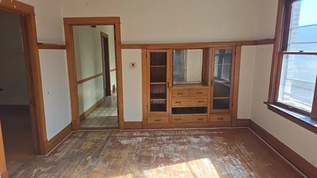 a view of an empty room with a fireplace and a window