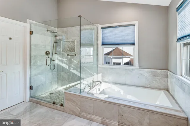 a en suite bathroom with a tub shower and window