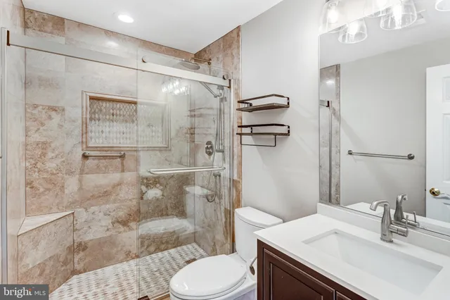 a bathroom with a sink toilet and shower
