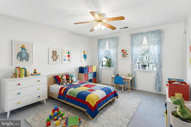 a bedroom that has a bed and a baby bed