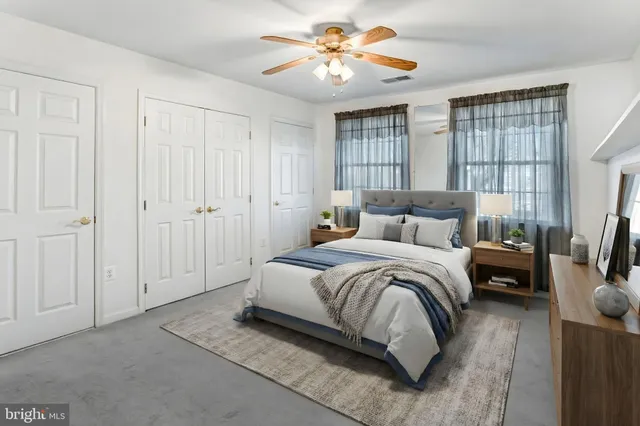 a spacious bedroom with a bed and a chandelier