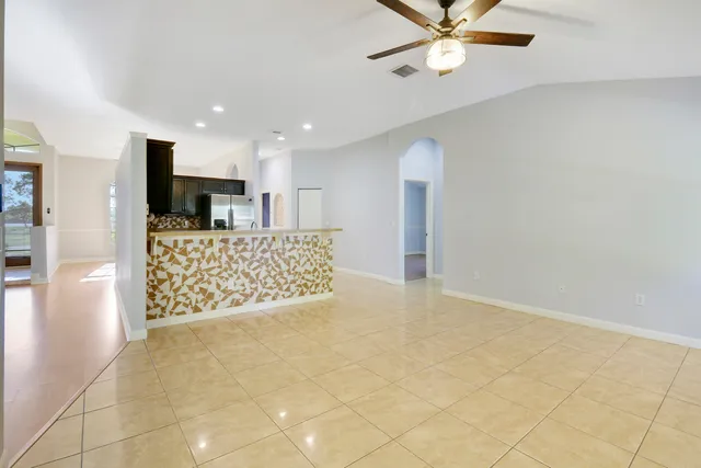 a view of kitchen with sink and refrigerator