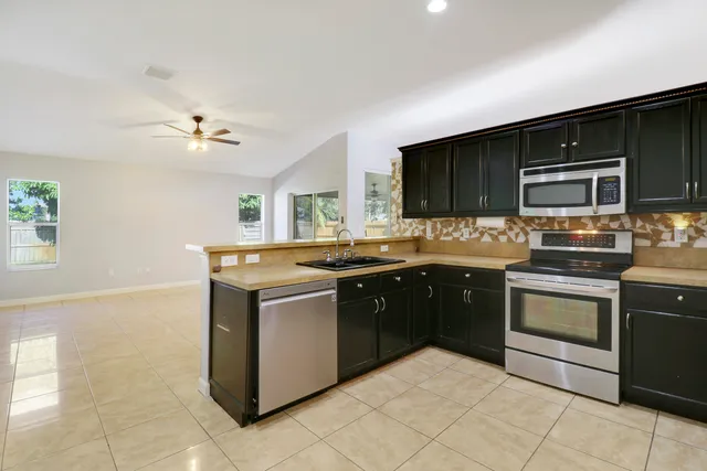a kitchen with stainless steel appliances granite countertop a stove and a sink