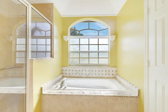 a bathroom with a bathtub and a window