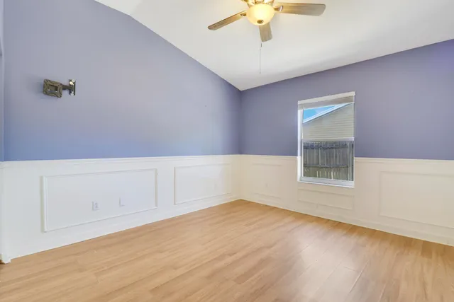wooden floor in an empty room with a window
