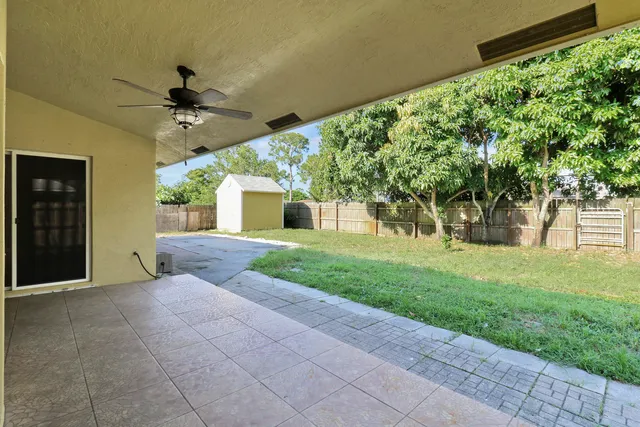 a view of a house with a yard and tree