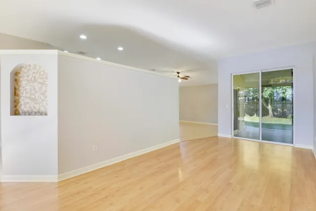 a view of an empty room with glass door