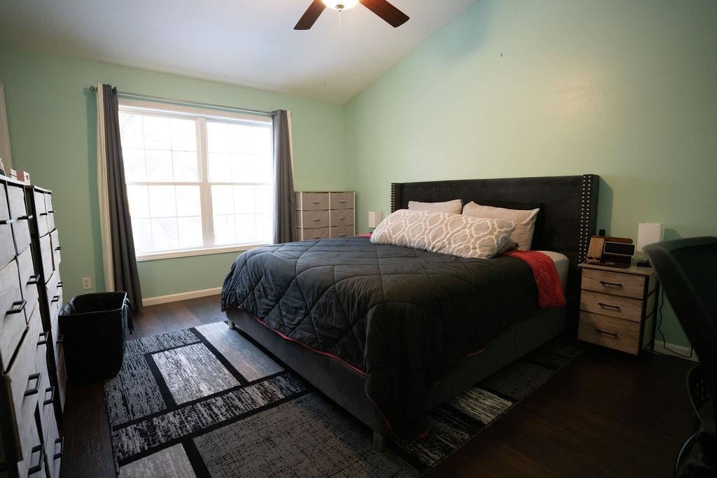 241 Rochester Road Northeast Poplar Grove, IL 61065 - Photo 13 of 32 a bedroom with a bed lamp on table and a window