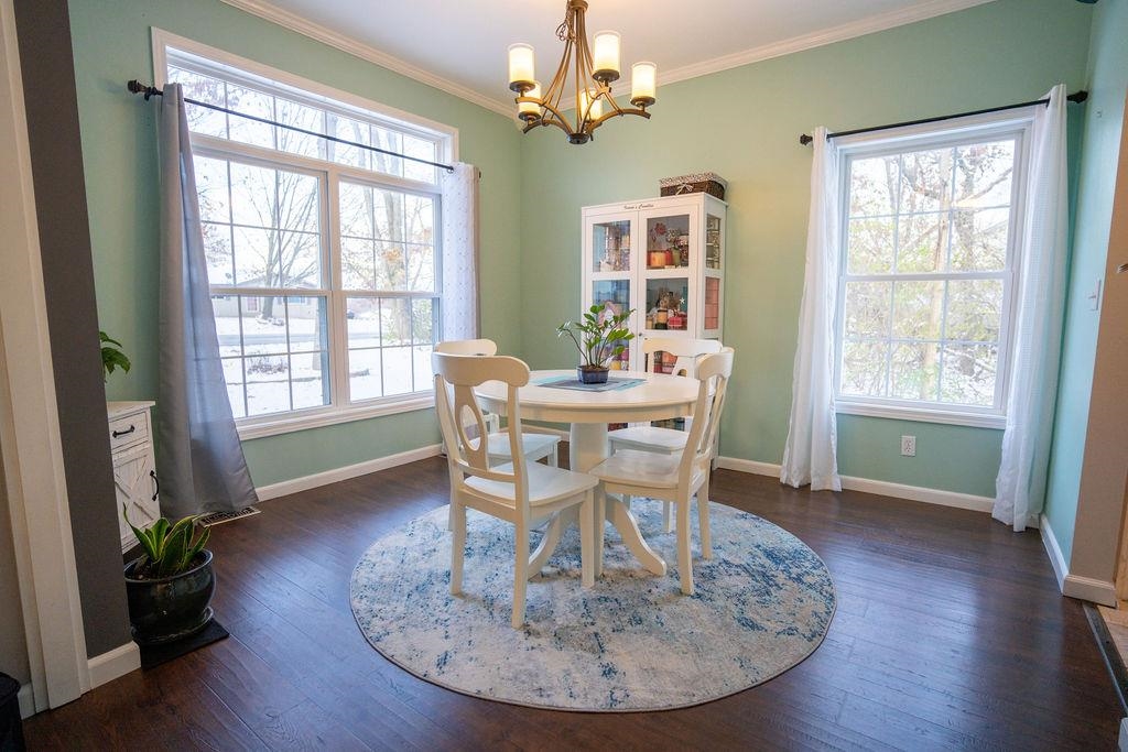 241 Rochester Road Northeast Poplar Grove, IL 61065 - Photo 6 of 32 a dining room with furniture a chandelier and wooden floor