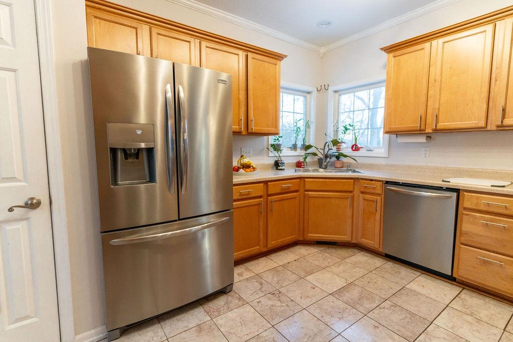 241 Rochester Road Northeast Poplar Grove, IL 61065 - Photo 8 of 32 a kitchen with a refrigerator sink and cabinets