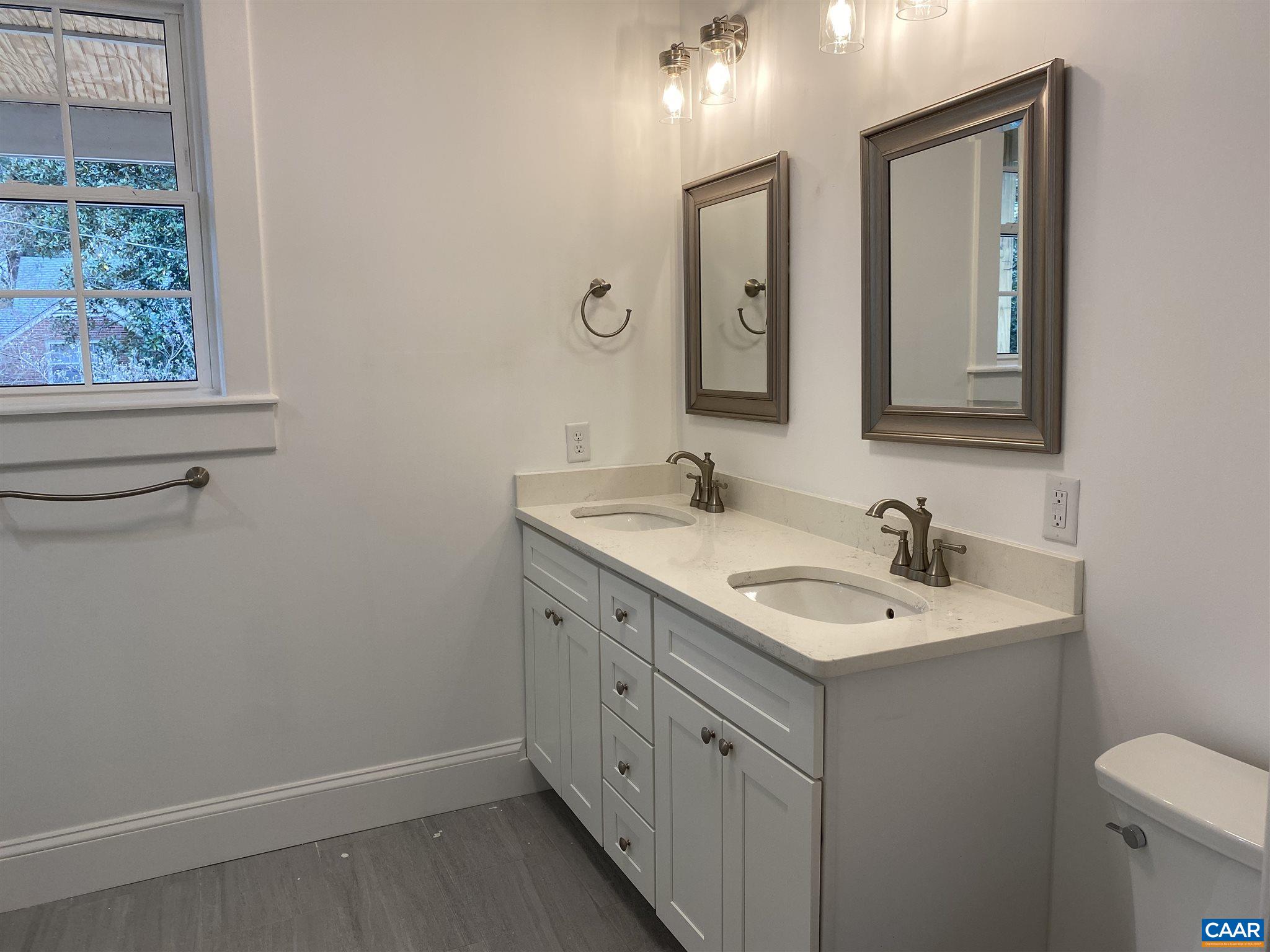 1928 Lewis Mountain Road, Unit B Charlottesville, VA 22903 - Photo 11 of 22 a bathroom with 2 sink and a mirror