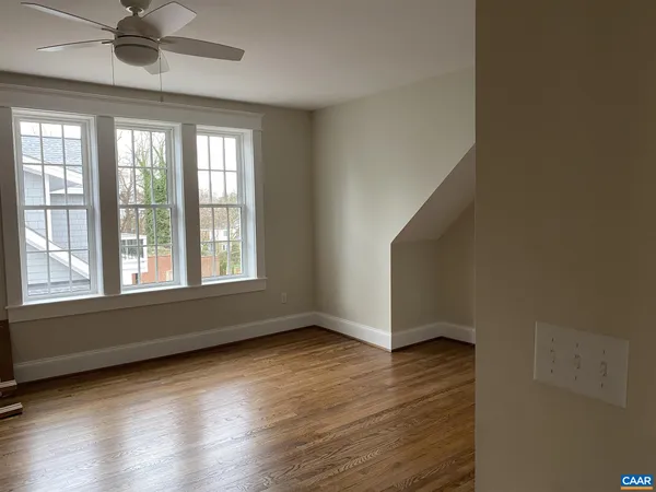 wooden floor in an empty room with a window
