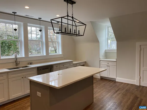 a kitchen that has a sink a window and stainless steel appliances