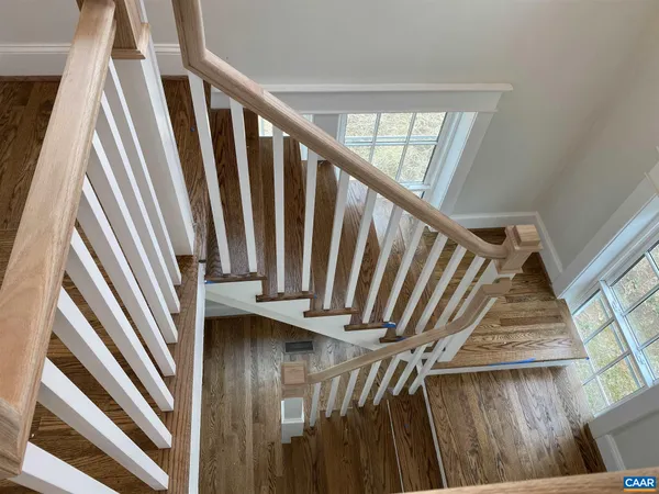 a view of staircase with railing and white walls