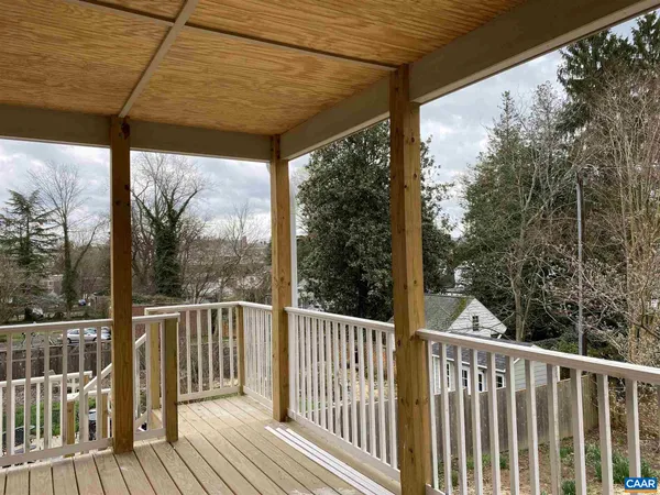 a view of a wooden deck next to a yard
