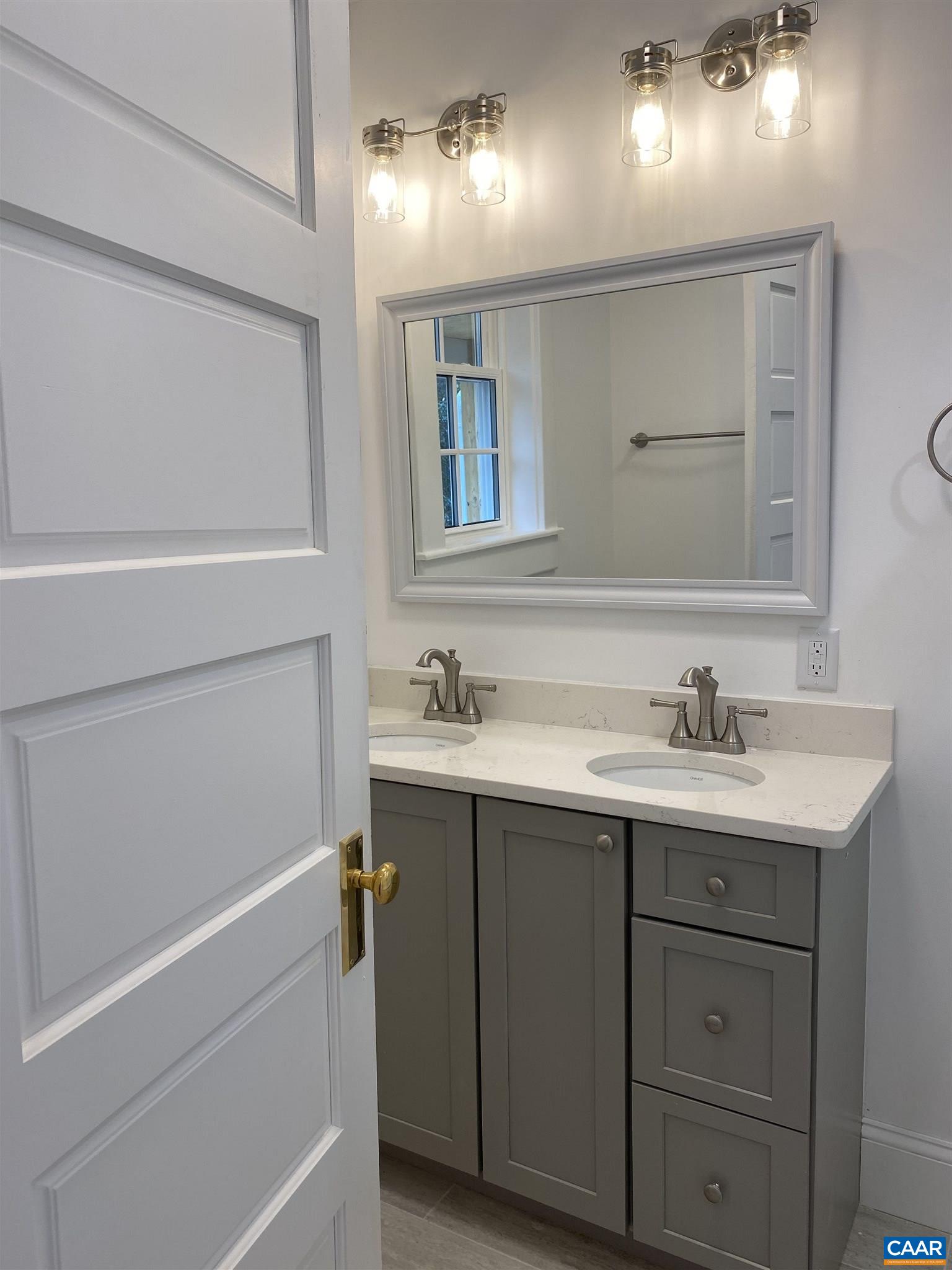 1928 Lewis Mountain Road, Unit B Charlottesville, VA 22903 - Photo 9 of 22 a bathroom with a sink and a mirror