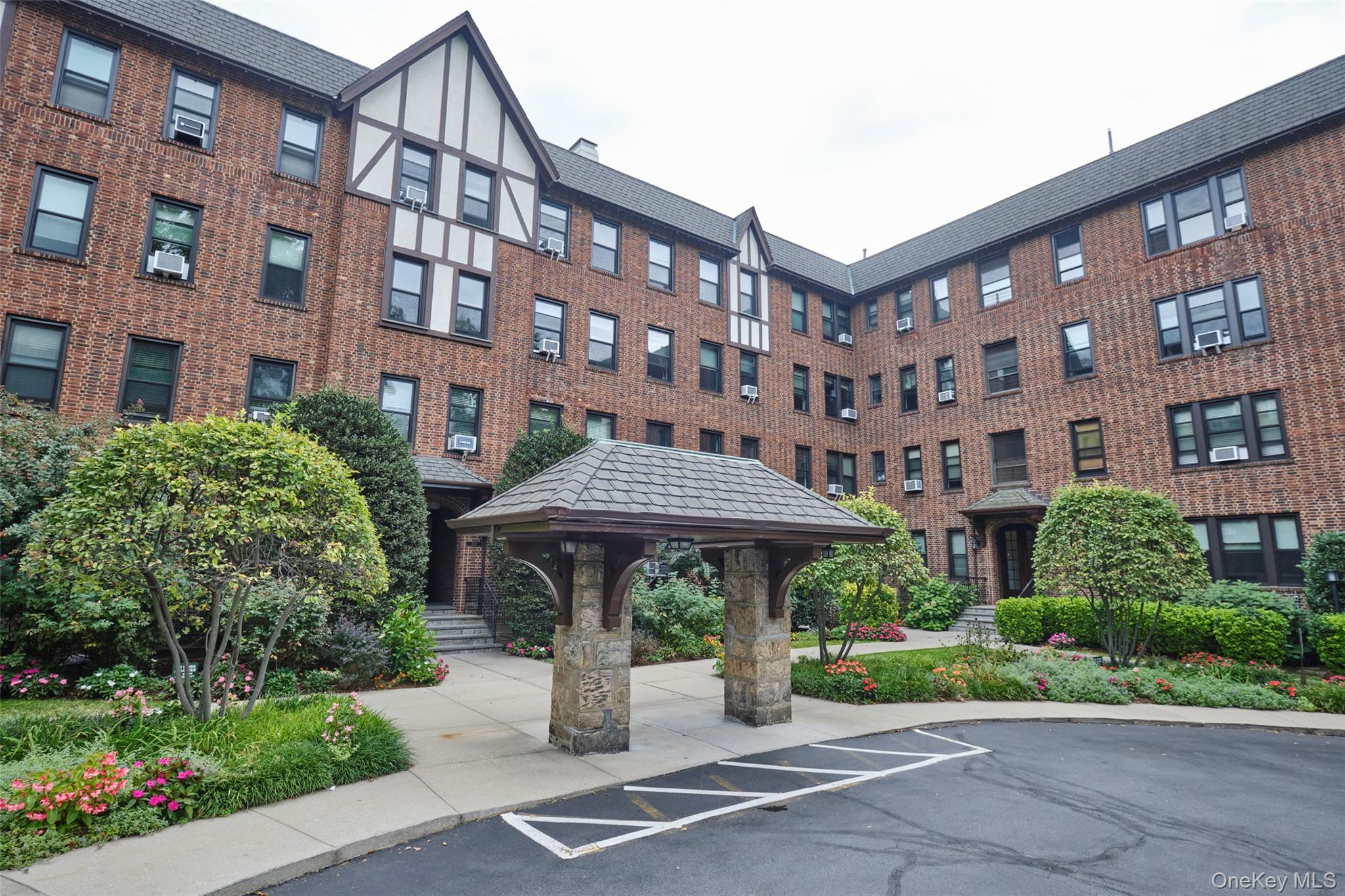 244 Bronxville Road, Unit G3 Bronxville, NY 10708 - Photo 16 of 18 a front view of a building with garden