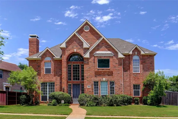 a front view of a house with yard