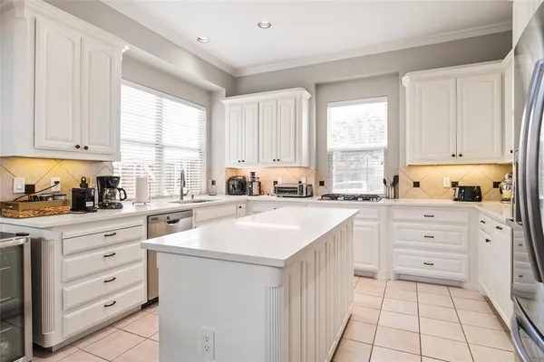 a kitchen with granite countertop white cabinets and white appliances