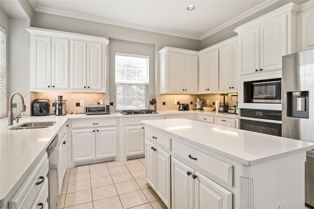 984 East Bethel School Road Coppell, TX 75019 - Photo 14 of 37 a kitchen with cabinets appliances a sink and a window