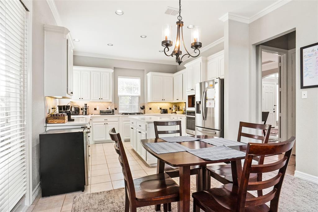 984 East Bethel School Road Coppell, TX 75019 - Photo 15 of 37 a view of a dining room with furniture window and wooden floor