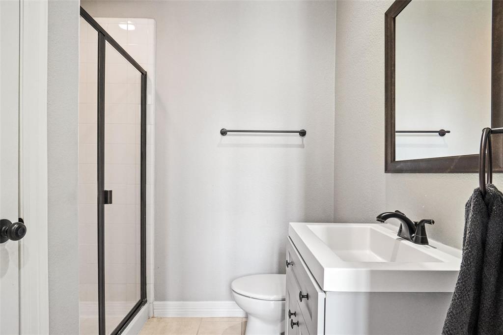 984 East Bethel School Road Coppell, TX 75019 - Photo 22 of 37 a bathroom with a sink toilet and vanity