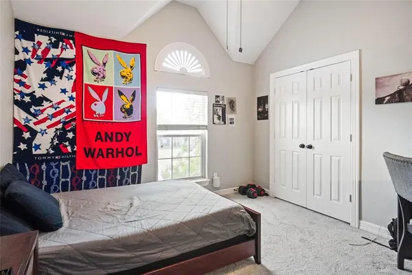 a bed room with a bed and a window