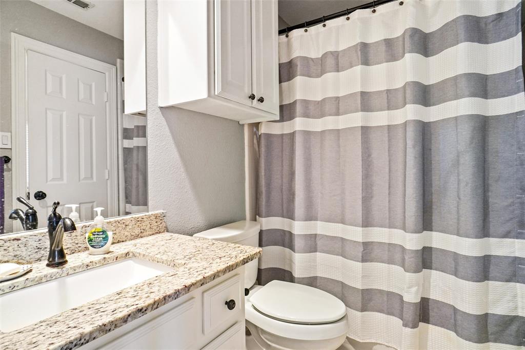 984 East Bethel School Road Coppell, TX 75019 - Photo 32 of 37 a bathroom with a granite countertop sink a toilet and a mirror