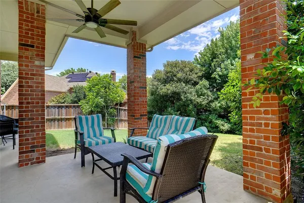 a view of a patio with table and chairs and potted plants