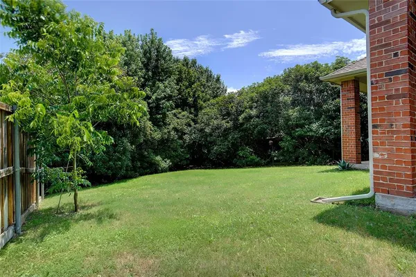 a backyard of a house with lots of green space