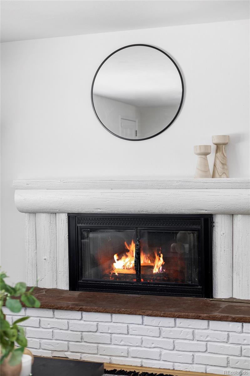 6563 Iris Street Arvada, CO 80004 - Photo 5 of 40 a view of fireplace and wooden floor
