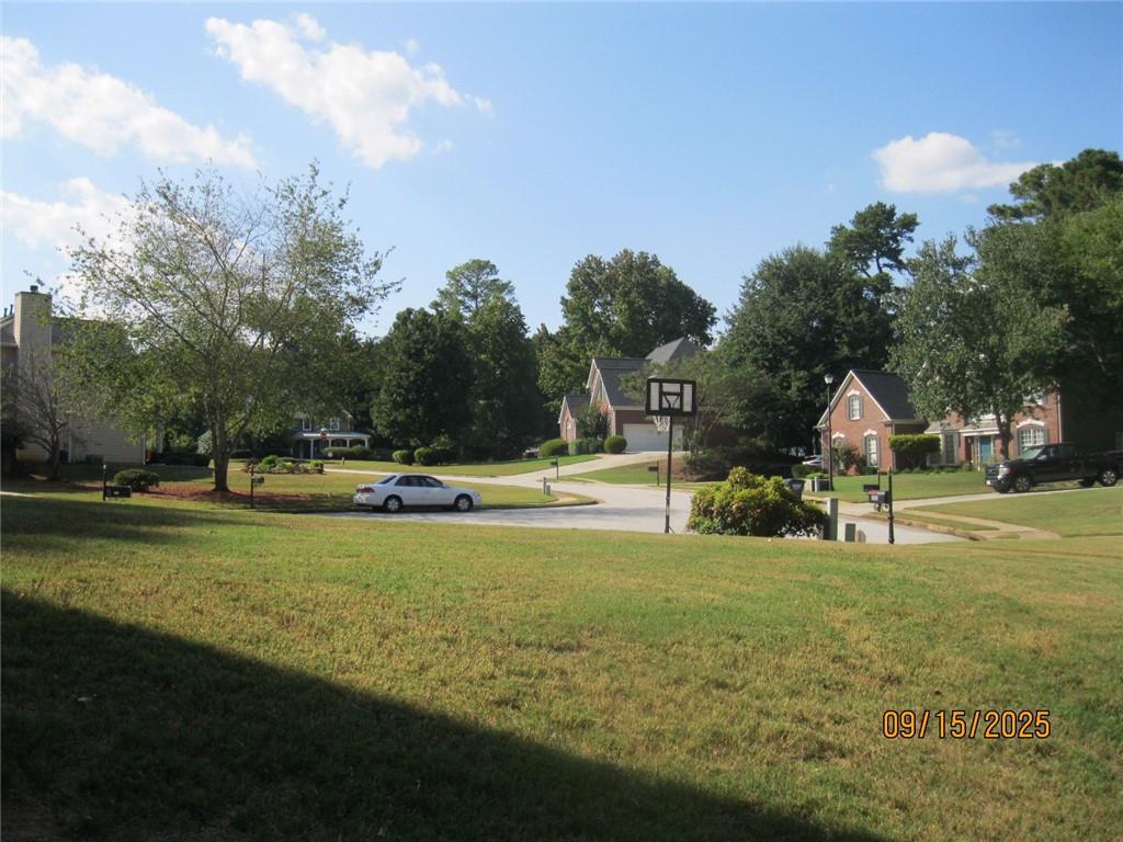 1105 Wake Robin Circle Southwest Lilburn, GA 30047 - Photo 2 of 20 a view of swimming pool and trees in the background