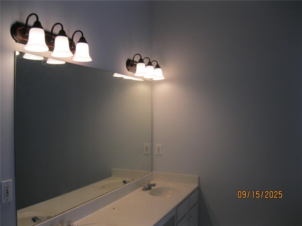 1105 Wake Robin Circle Southwest Lilburn, GA 30047 - Photo 10 of 20 a bathroom with a sink and a mirror
