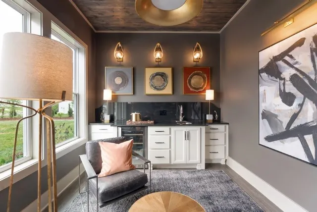 a living room with furniture a large window with kitchen view