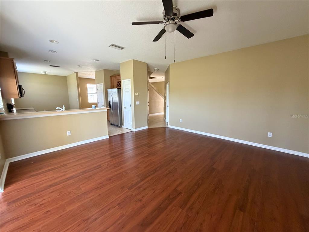 7514 Dragon Fly Loop Gibsonton, FL 33534 - Photo 5 of 11 a view of a big room with wooden floor and windows