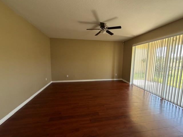 7514 Dragon Fly Loop Gibsonton, FL 33534 - Photo 9 of 11 an empty room with wooden floor fan and windows