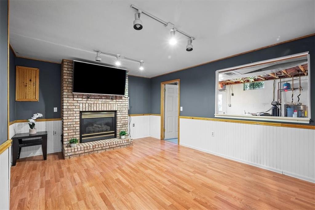 2086 Ridge Rd Extension Ambridge, PA 15003 - Photo 29 of 43 a big room with wooden floor a fireplace and a window