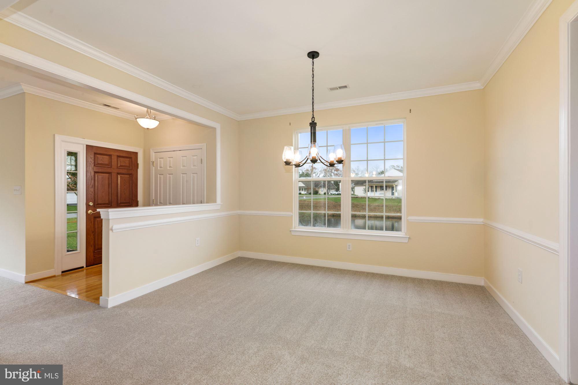 24873 Rivers Edge Road Millsboro, DE 19966 - Photo 12 of 57 Formal Dining Room with Decorative Moldings
