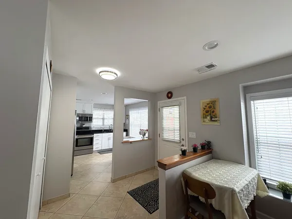 a view of a dining room with furniture and window