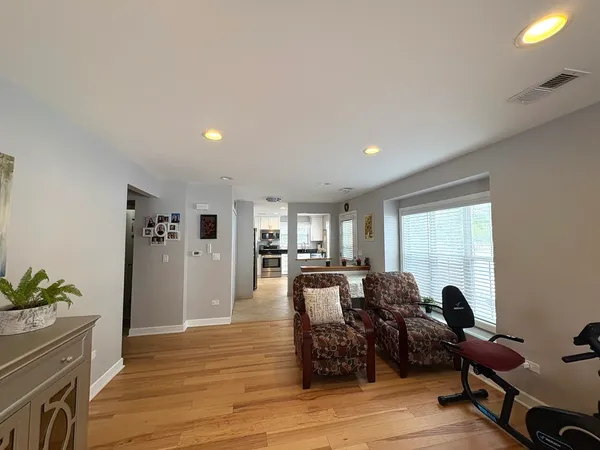 a living room with fireplace furniture and a wooden floor