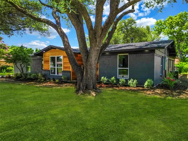 a front view of house with yard and green space