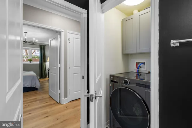 a view of a hallway with washer and dryer