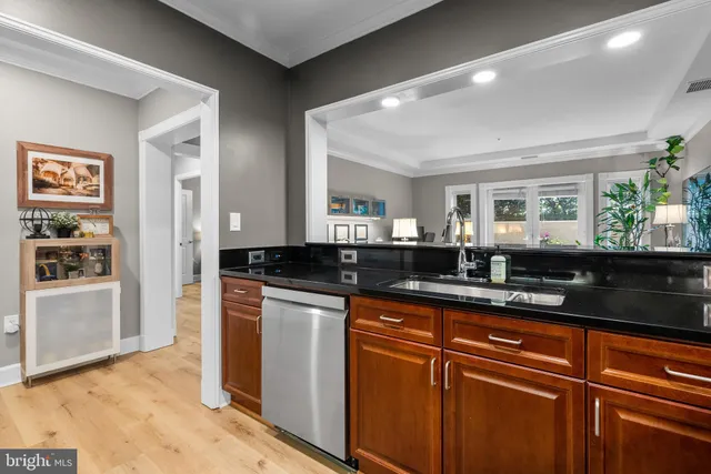 a kitchen with granite countertop cabinets a sink and stainless steel appliances