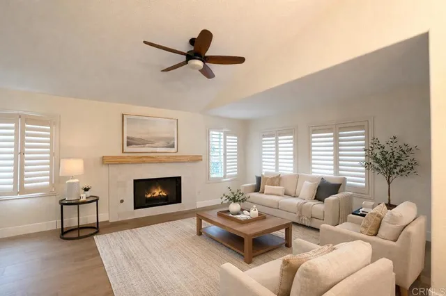 a living room with furniture fireplace and window