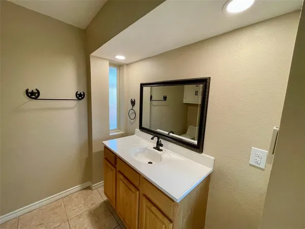a bathroom with a sink a mirror and a shower