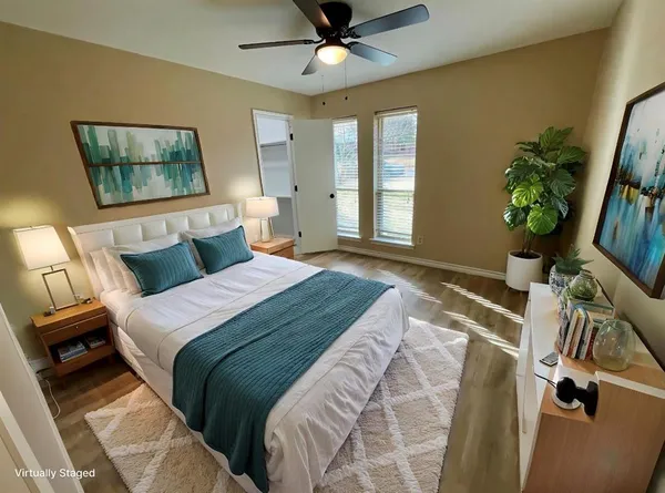 a bedroom with a bed and a large window