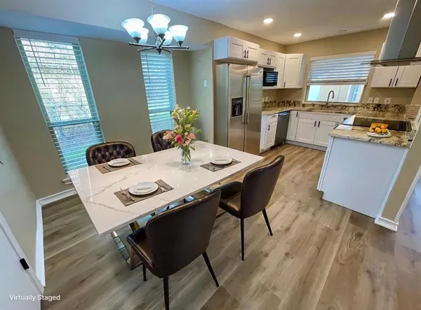 a kitchen with a table and chairs in it
