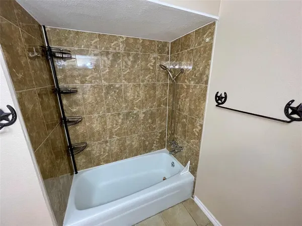 a bathroom with a tub and a shower