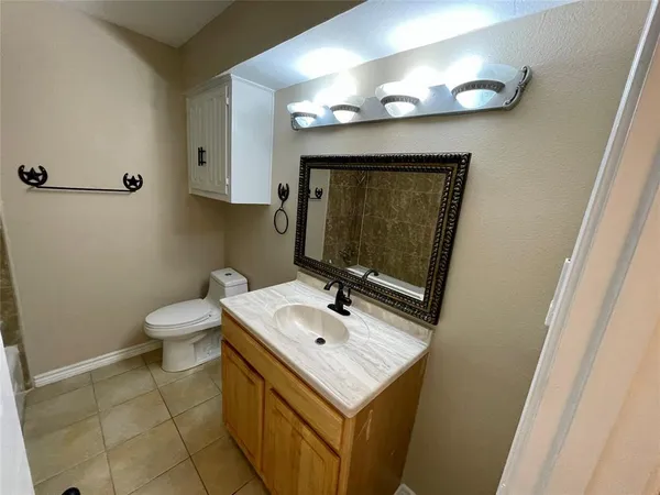 a bathroom with a sink toilet and mirror