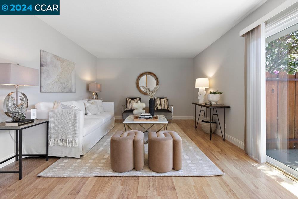 a living room with furniture a table and wooden floor